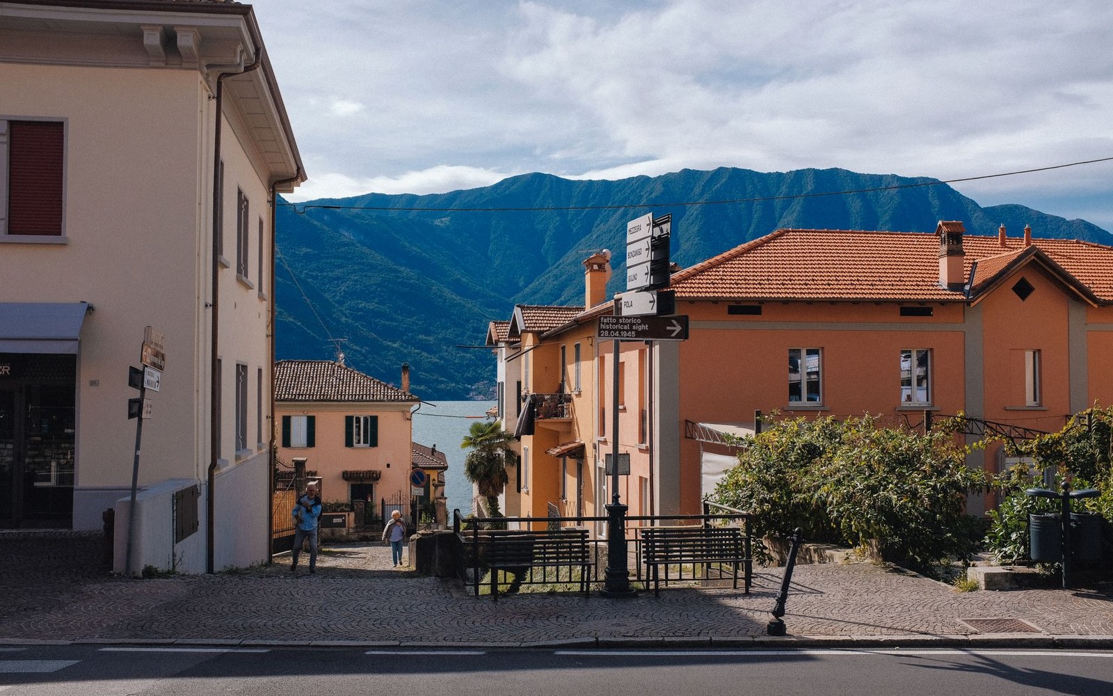 Two adults talking on a village street in southern Italy